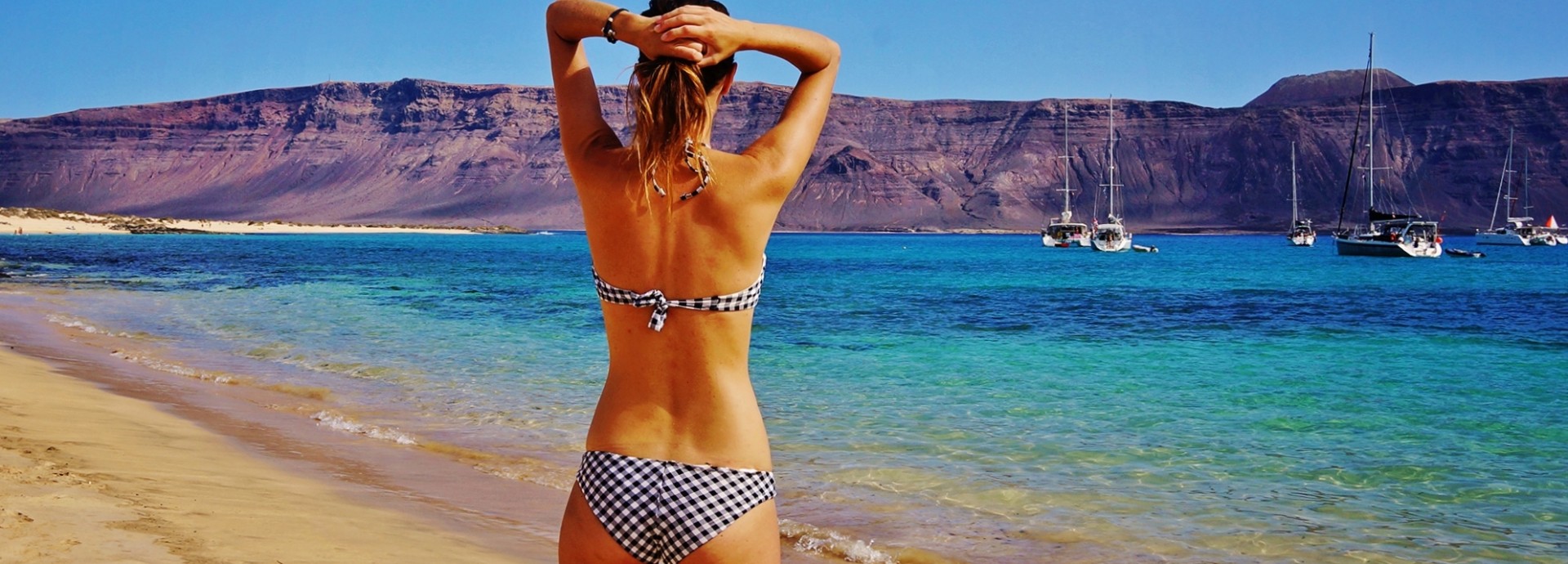 Jess chilling on a beach in the Canary Islands