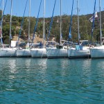 Flotilla rafted in a bay in the Saronic Islands by Patrick Bellew