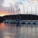 Flotilla rafted in a bay at sunset