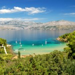 Lovrecina Beach on Brac Islands with yachts in bay