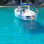 Alex sitting on the back of the Beneteau 38