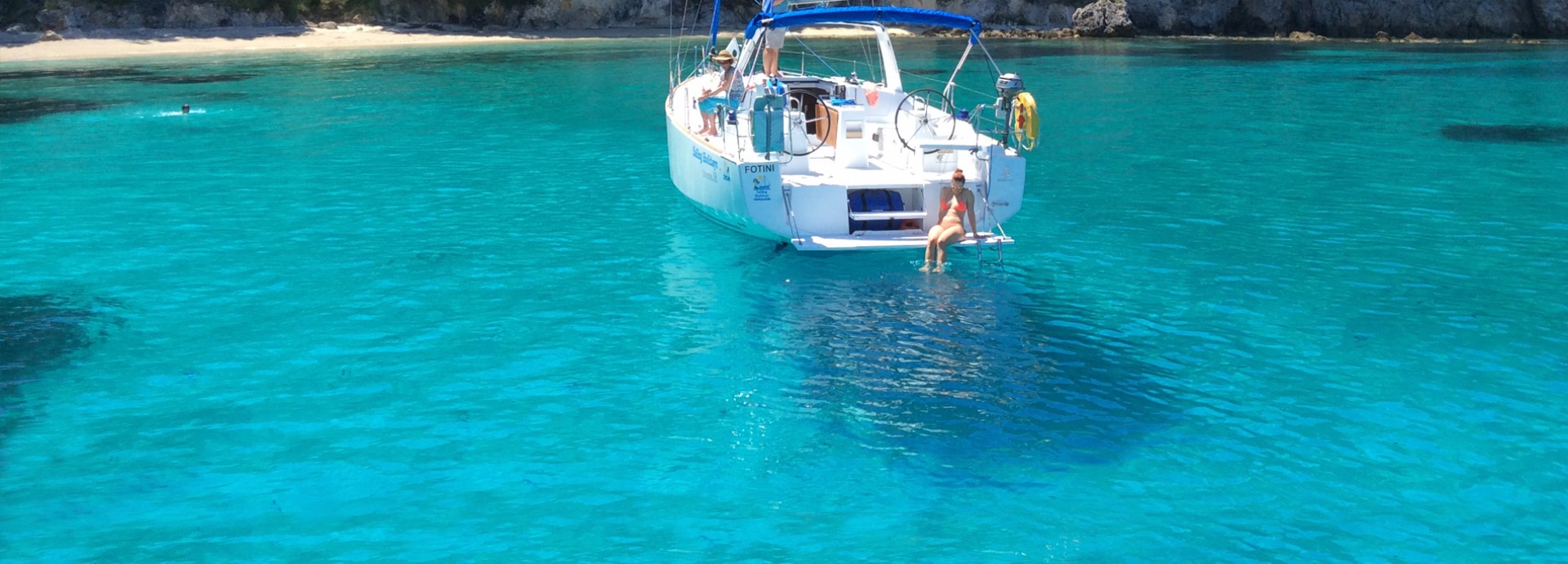 Alex sitting on the back of the Beneteau 38