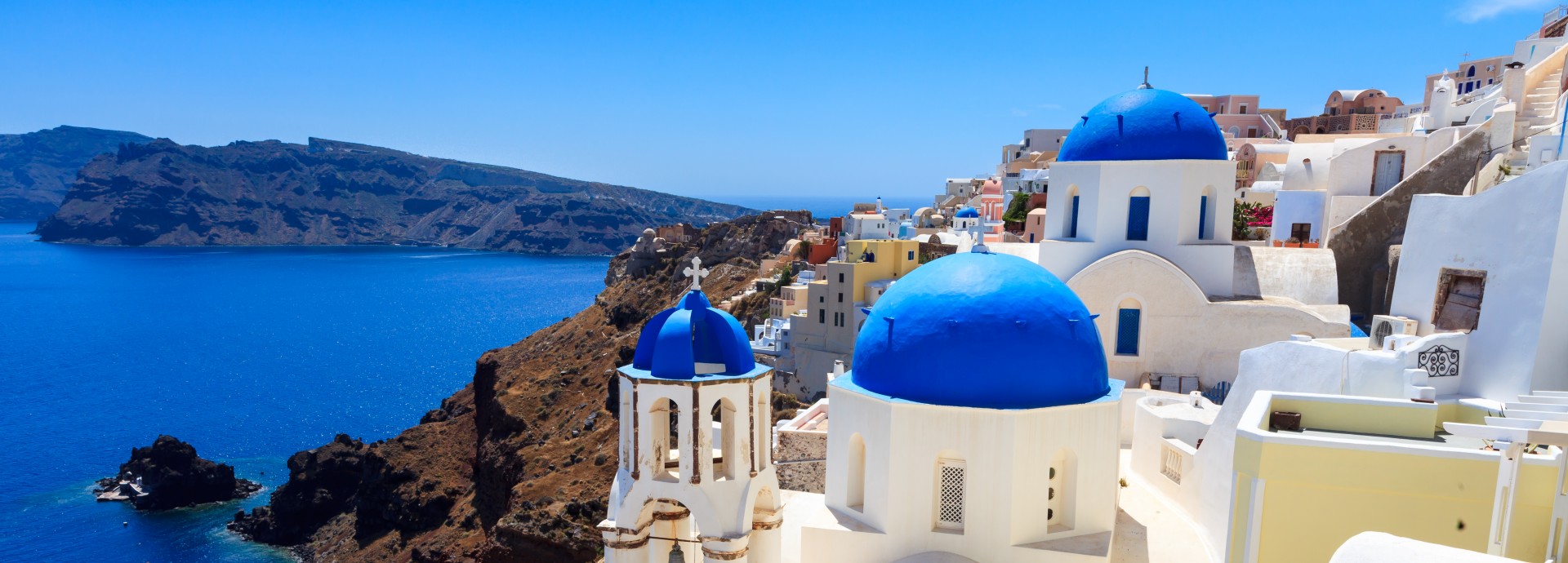 Panoramic view Santorini with blue domed church