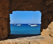 Rhodes yacht through peephole in fortress